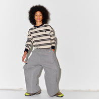 Kid wearing a Main Story long sleeve band tee with ivory and black stripes and gray  sweatpants