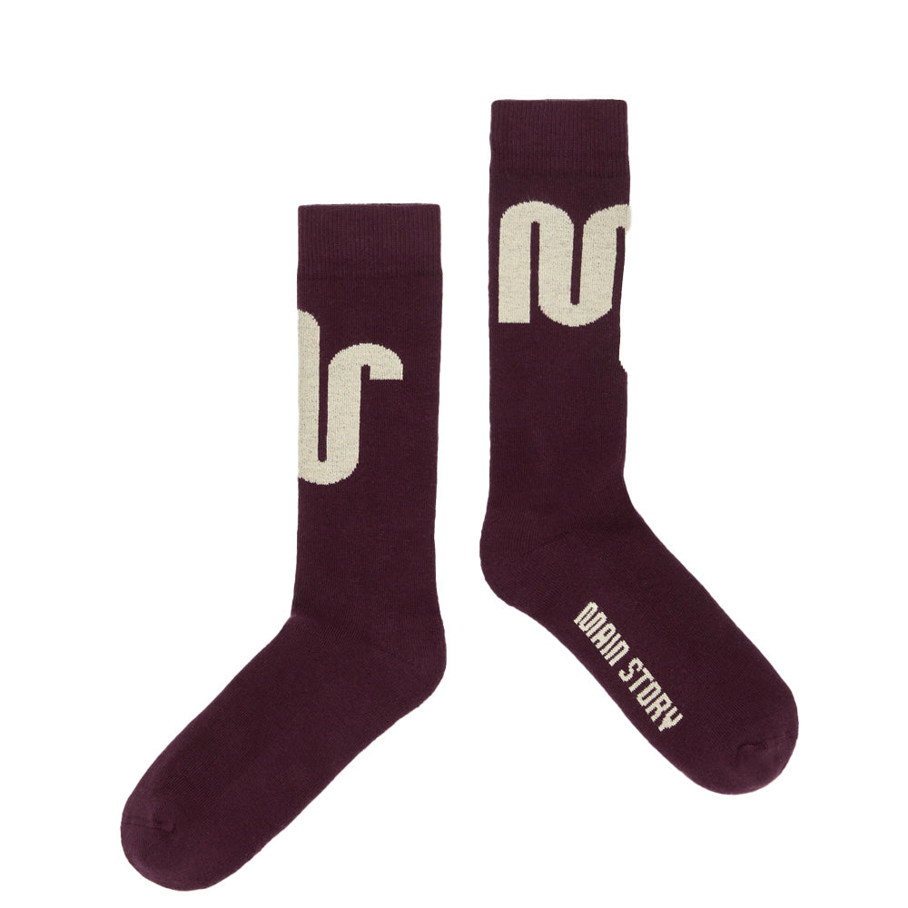 Pair of Main Story maroon socks with ivory logo and text on a white background