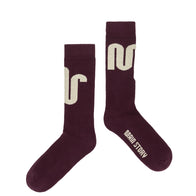 Pair of Main Story maroon socks with ivory logo and text on a white background