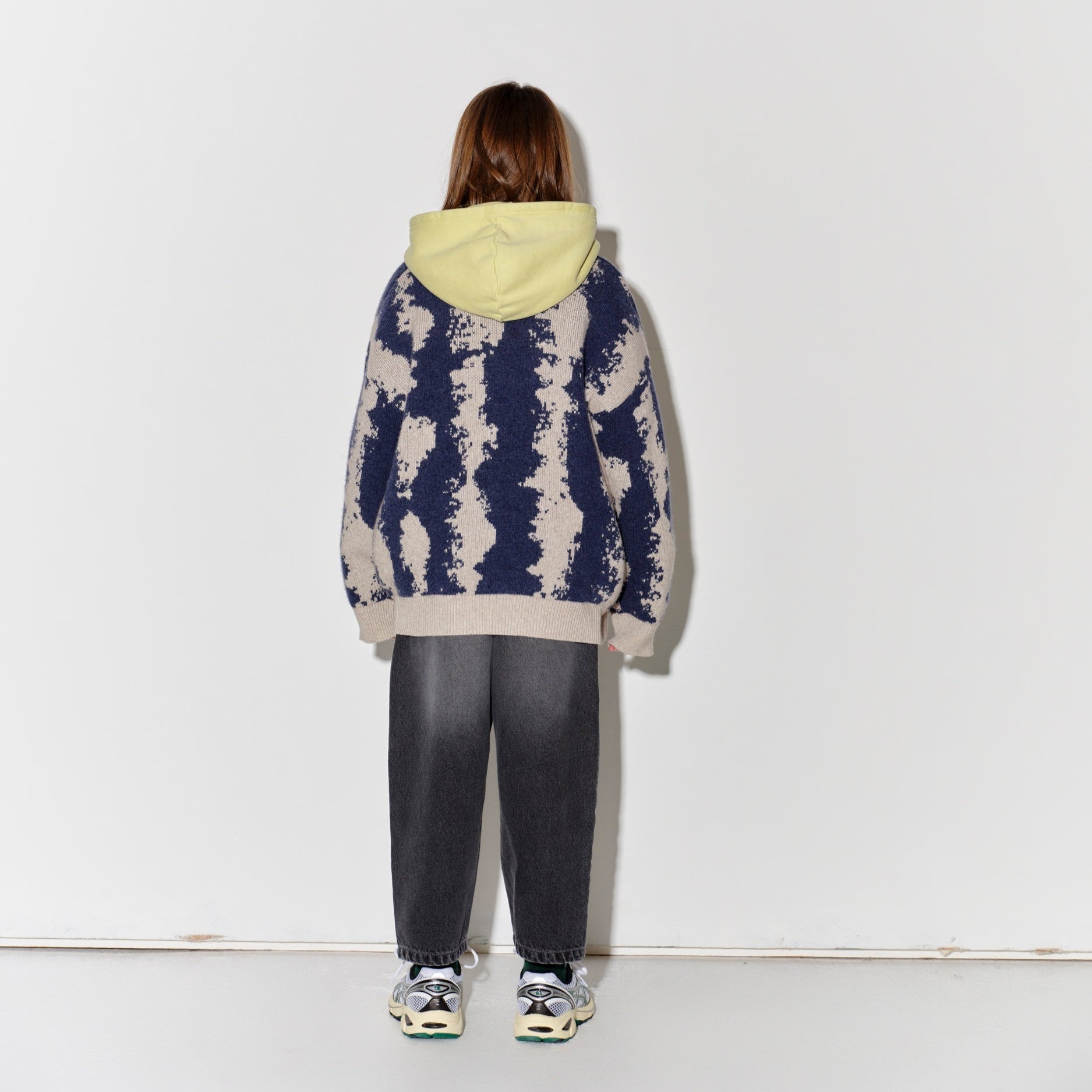 Child wearing Main Story knit cardigan in oat/navy with faded baggy black jeans
