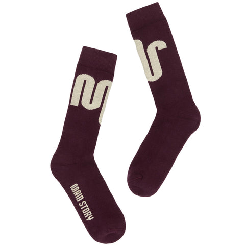 Pair of Main Story maroon socks with an off-white logo on a white background