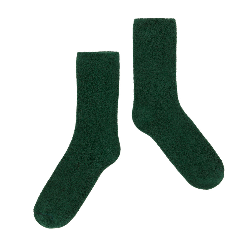 Pair of dark green  Main Story socks on a white background